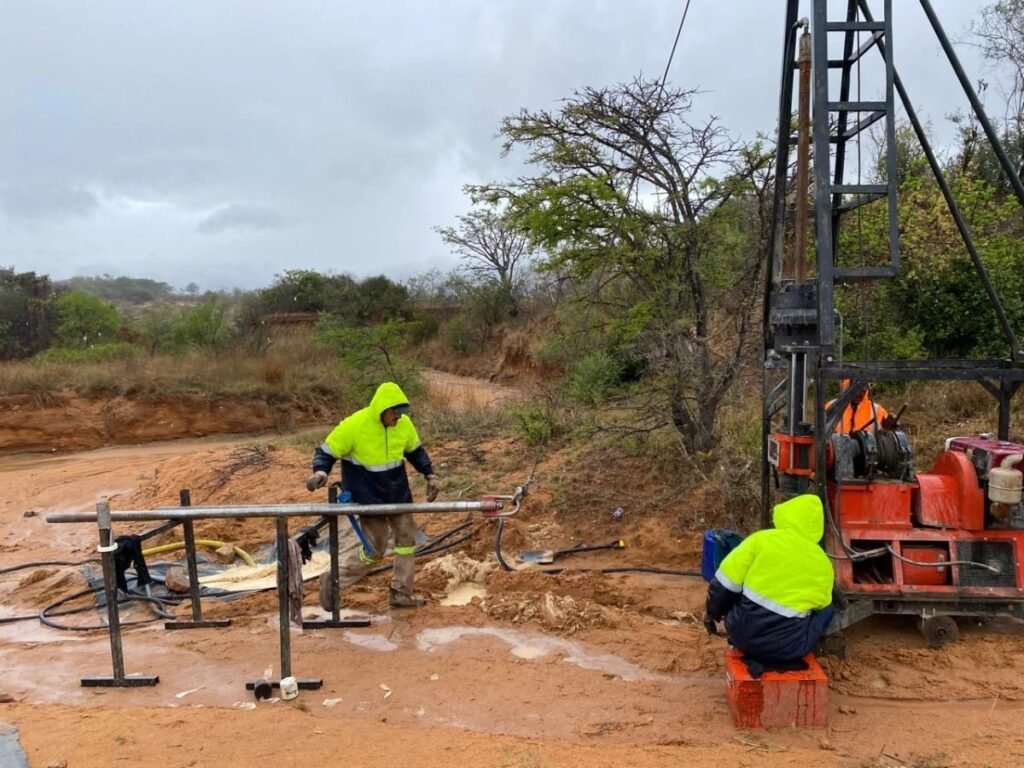 Tau Africa crew operating a geotechnical drilling rig on site